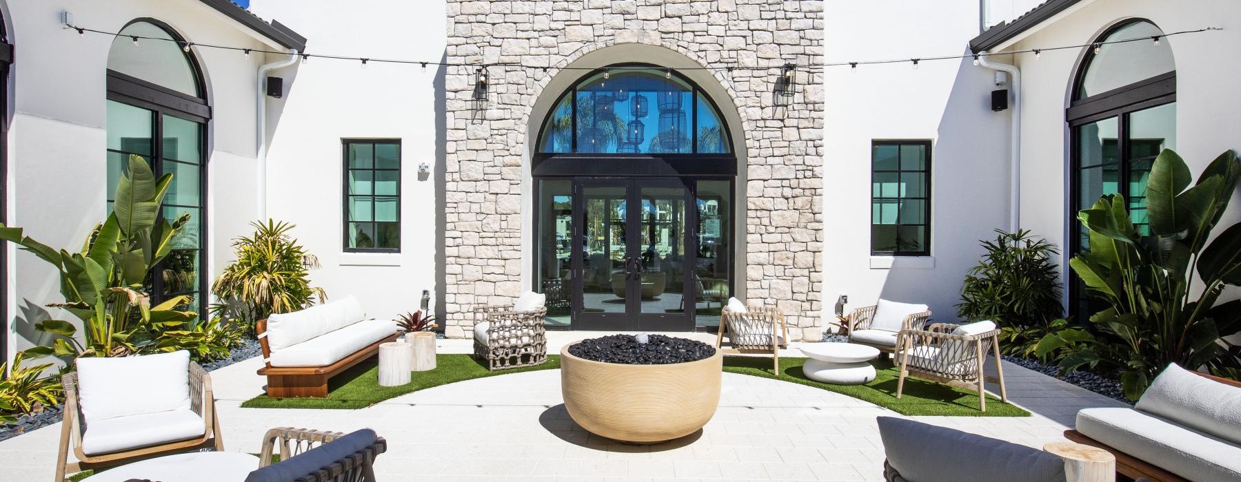 a courtyard with chairs and tables