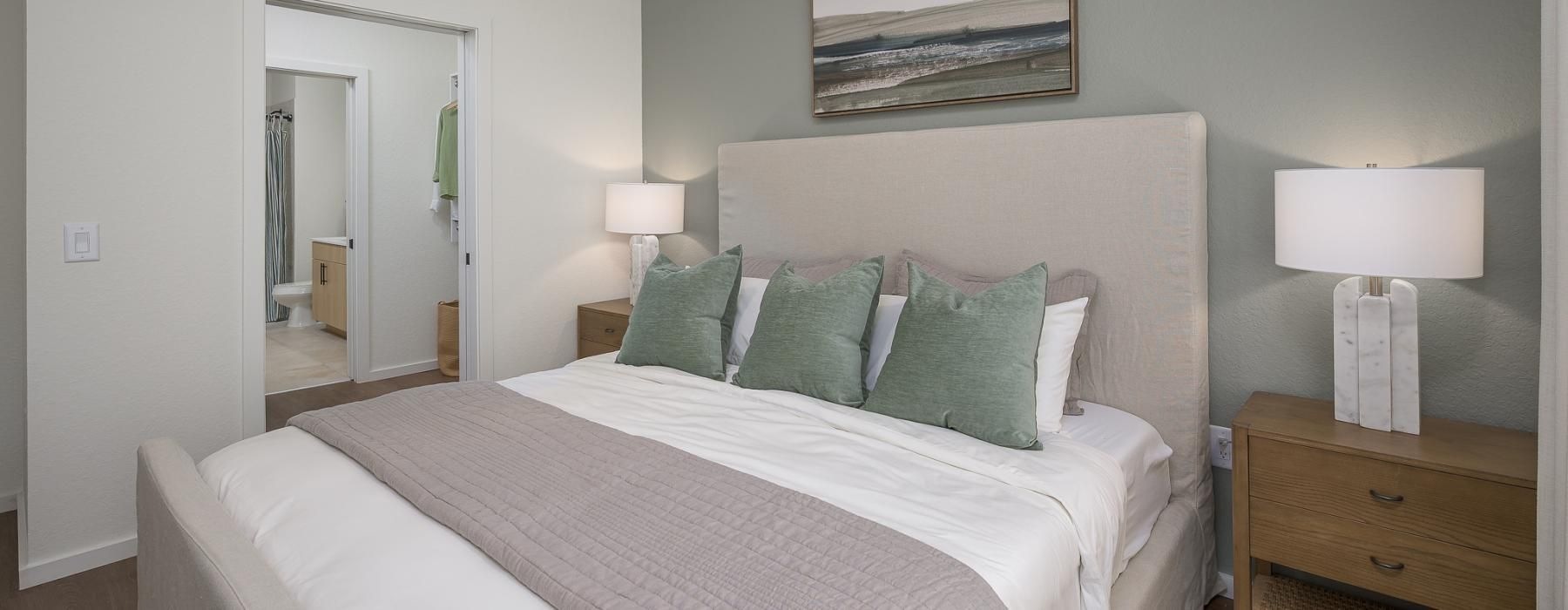 a bed with green pillows