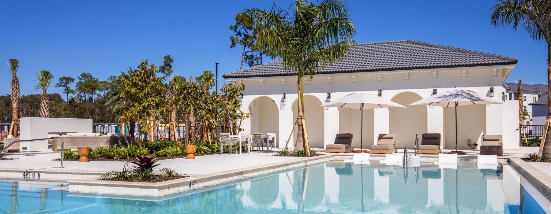 a swimming pool with a house in the background