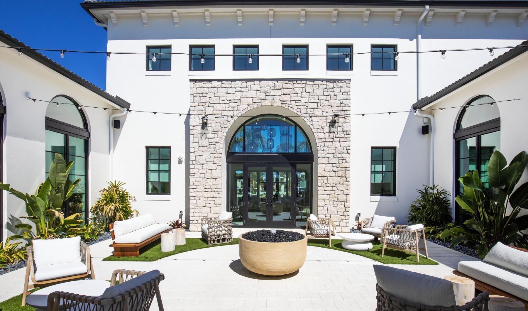 a courtyard with chairs and tables