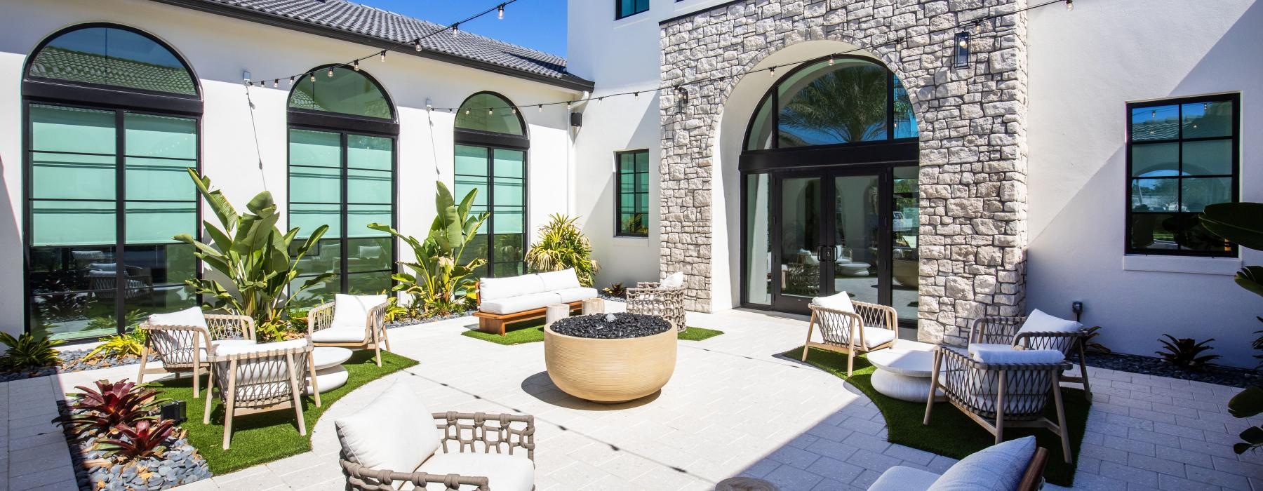 a patio with chairs and tables
