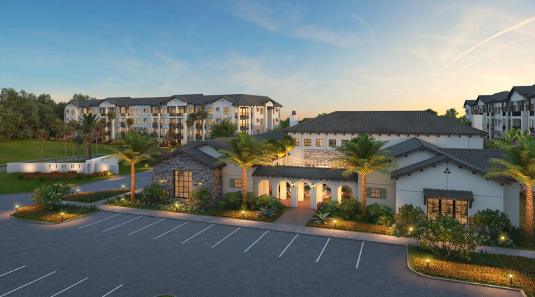 view of exterior of Fiori clubhouse at sunset with lights on