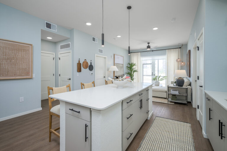 kitchen with white countertops and view of living room and patio