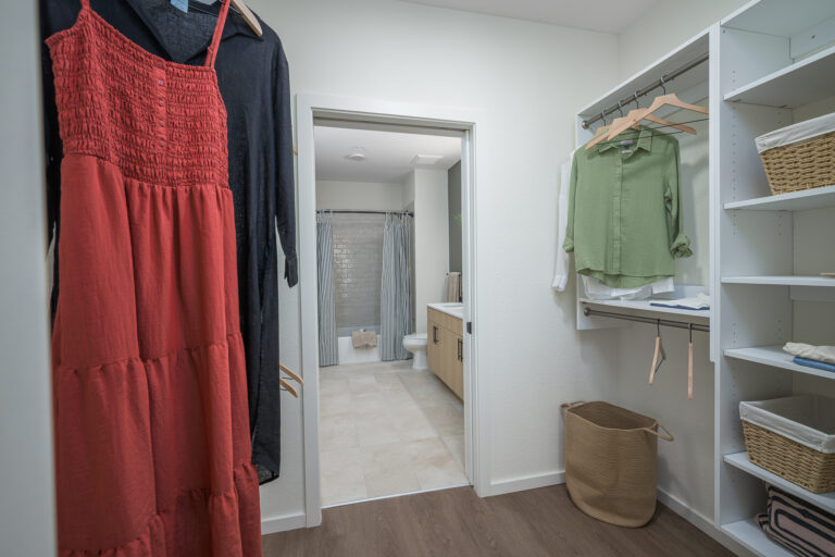 giant closet with view of bathroom