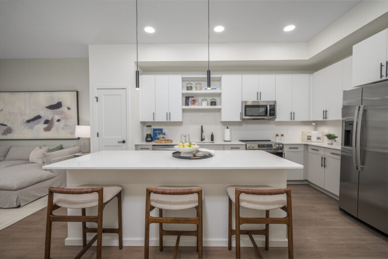 kitchen with white countertops, island, stools, and white cabinets