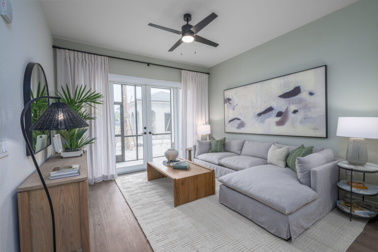 living room with double patio doors and ceiling fan