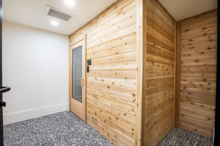 Sauna entrance with wood paneling at Fiori Apartments